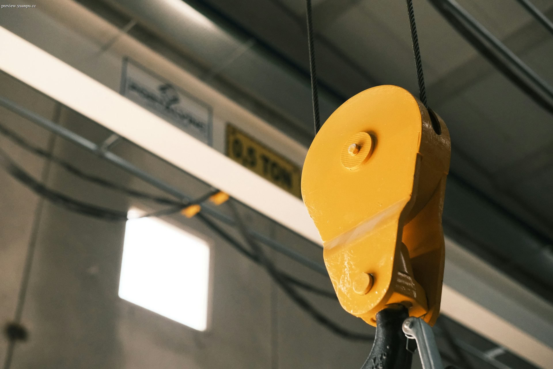 Industrial overhead crane lifting a heavy load